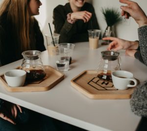 a group of people sitting around a white table